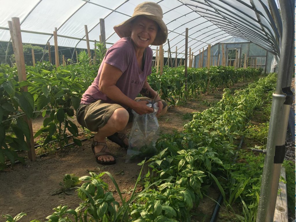 smiling farmer in the greenhouse